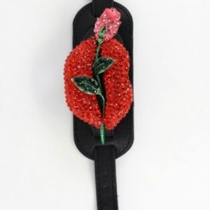 Rhinestone lip and leaves leather wrist cuff.